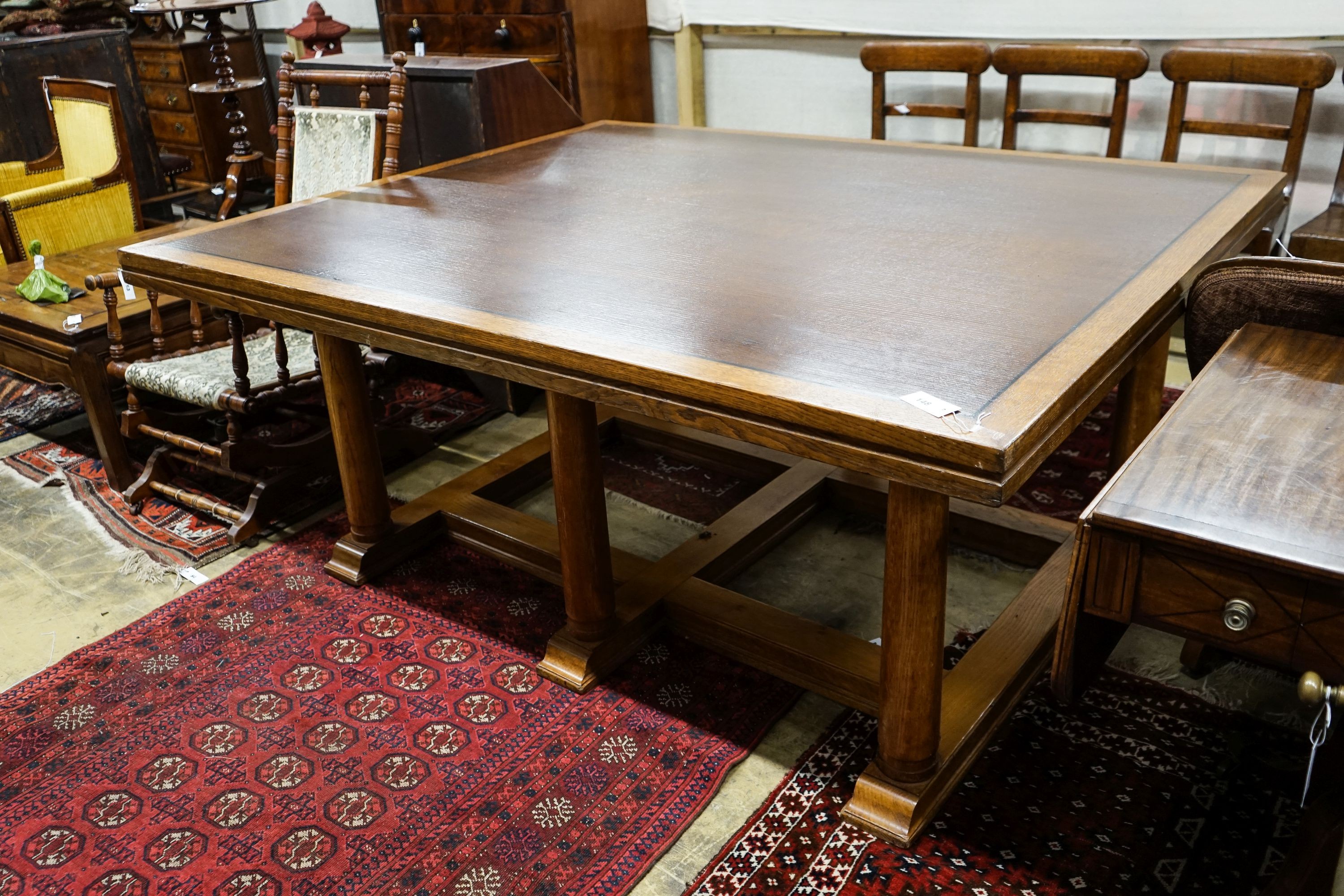 A large rectangular oak dining or boardroom table on six column supports (From The Wills Cigarette Factory, Newcastle), length 182cm, depth 152cm, height 77cm